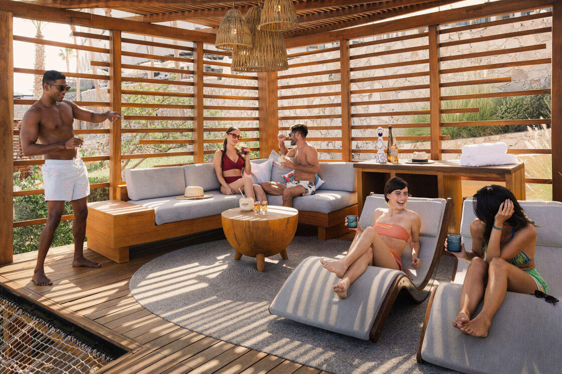 picture of people sitting in an open cabin near the pool