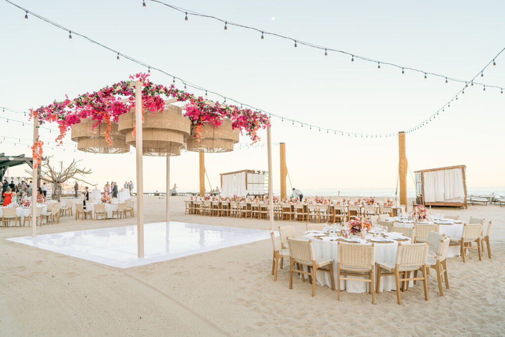Beachfront event at Hilton Los Cabos with floral decor, string lights, and a sunset-ready dance floor on the sand.