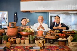 Executive Chef and Talavera team at Hilton Los Cabos showcasing traditional Mexican dishes, fresh ingredients, and festive table setting.