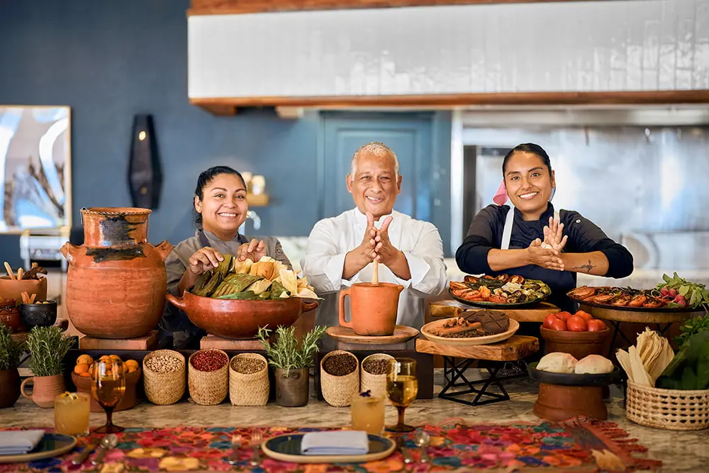 Executive Chef and Talavera team at Hilton Los Cabos showcasing traditional Mexican dishes, fresh ingredients, and festive table setting.