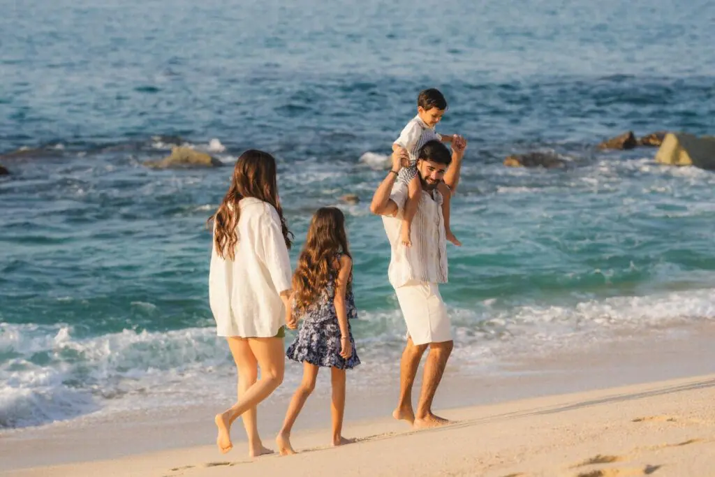 Family of four walking on the beach
