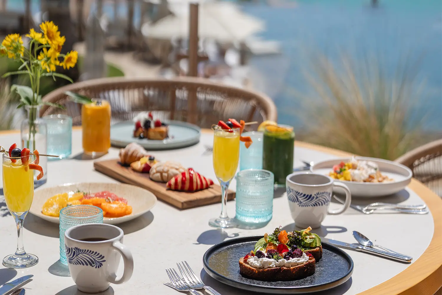 A poolside brunch spread with mimosas, pastries, and shrimp cocktail at Talavera restaurant at Hilton Los Cabos Beach & Golf Resort
